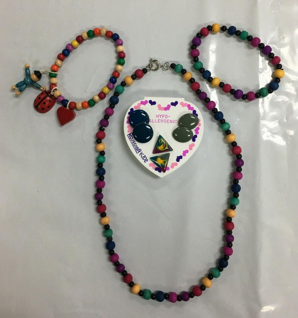 Rosecraft Kids Earrings, Wooden Necklace, and Two Bracelets Jewelry Set: This set is in excellent condition without any visible flaws. It includes set of 3 pair of Rosecraft earrings, wooden necklace and two wooden bracelets. There are no names on the necklace and bracelet