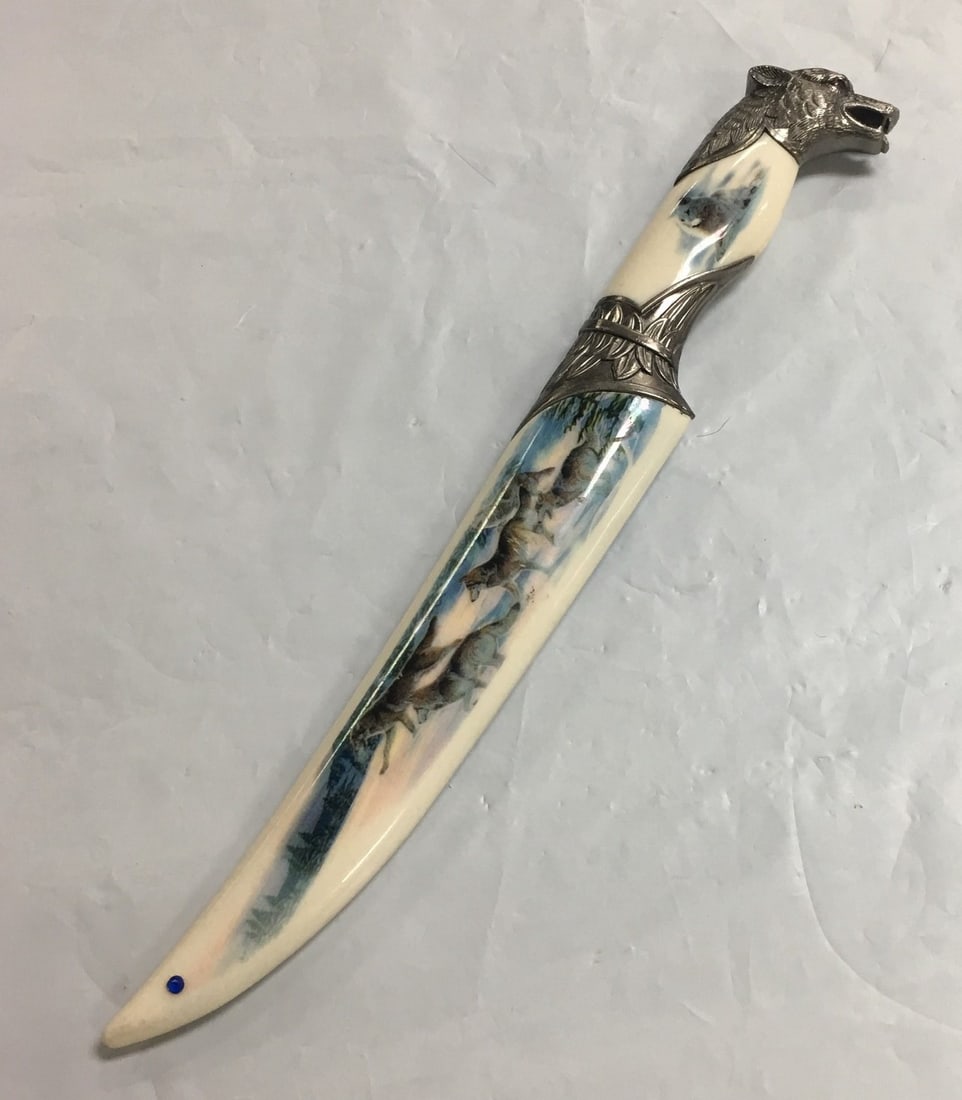 Collector's Hunting Knife with Arctic Wolf Head and Etched Blade 13": This beautiful knife is in excellent, like new condition without any visible flaws. The knife measures about 13" long with a blade length of 8". Please, review pictures for condition and details.