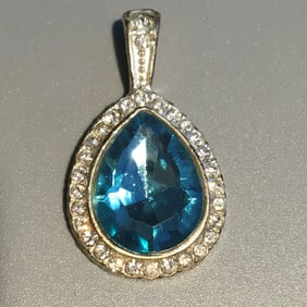 Blue Stone Surrounded by White Stones Set in Silver Pendant