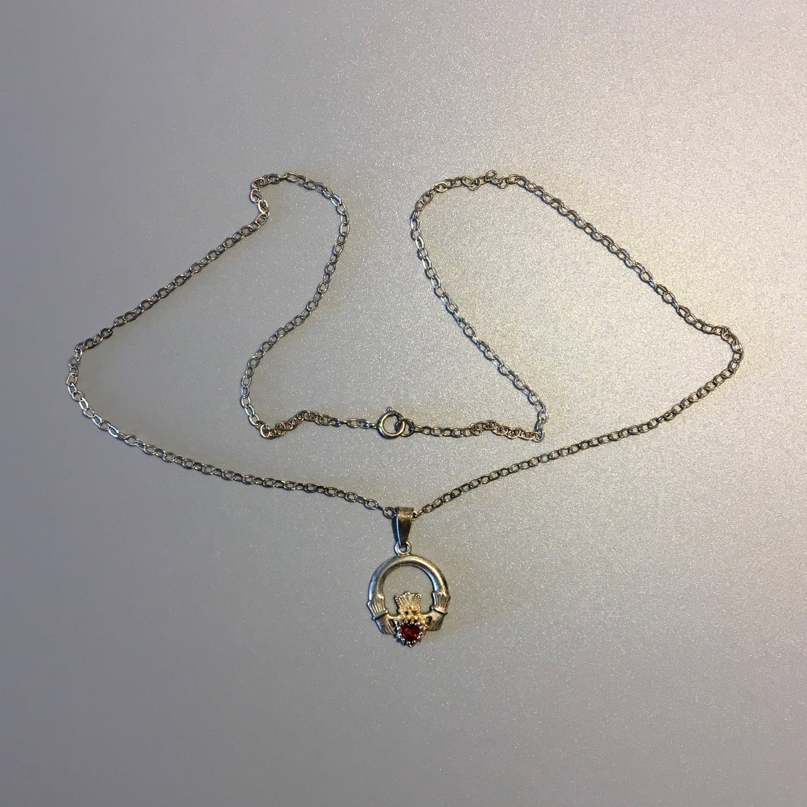 Silver and Garnet Pendant Necklace: Silver and Garnet Pendant Necklace, Pendant is Marked .80, Length 10 in. 1.8 dwt.