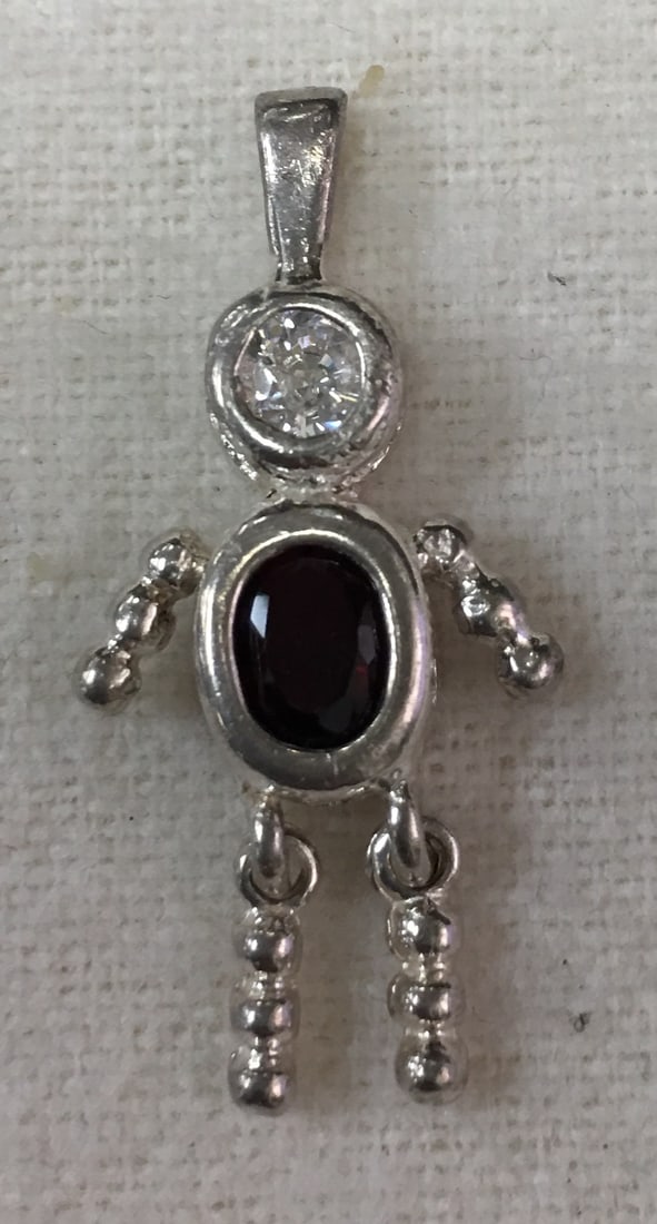 .925 Sterling Silver Man Figure Charm Pendant with Garnet and CZ Stones: This charm pendant is in excellent condition with little signs of wear seen. It is marked 925. It is measures about 1 1/8" by 1/2" with a weight of 1.40 dwt or 2.10 grams. Please, review pictures for 