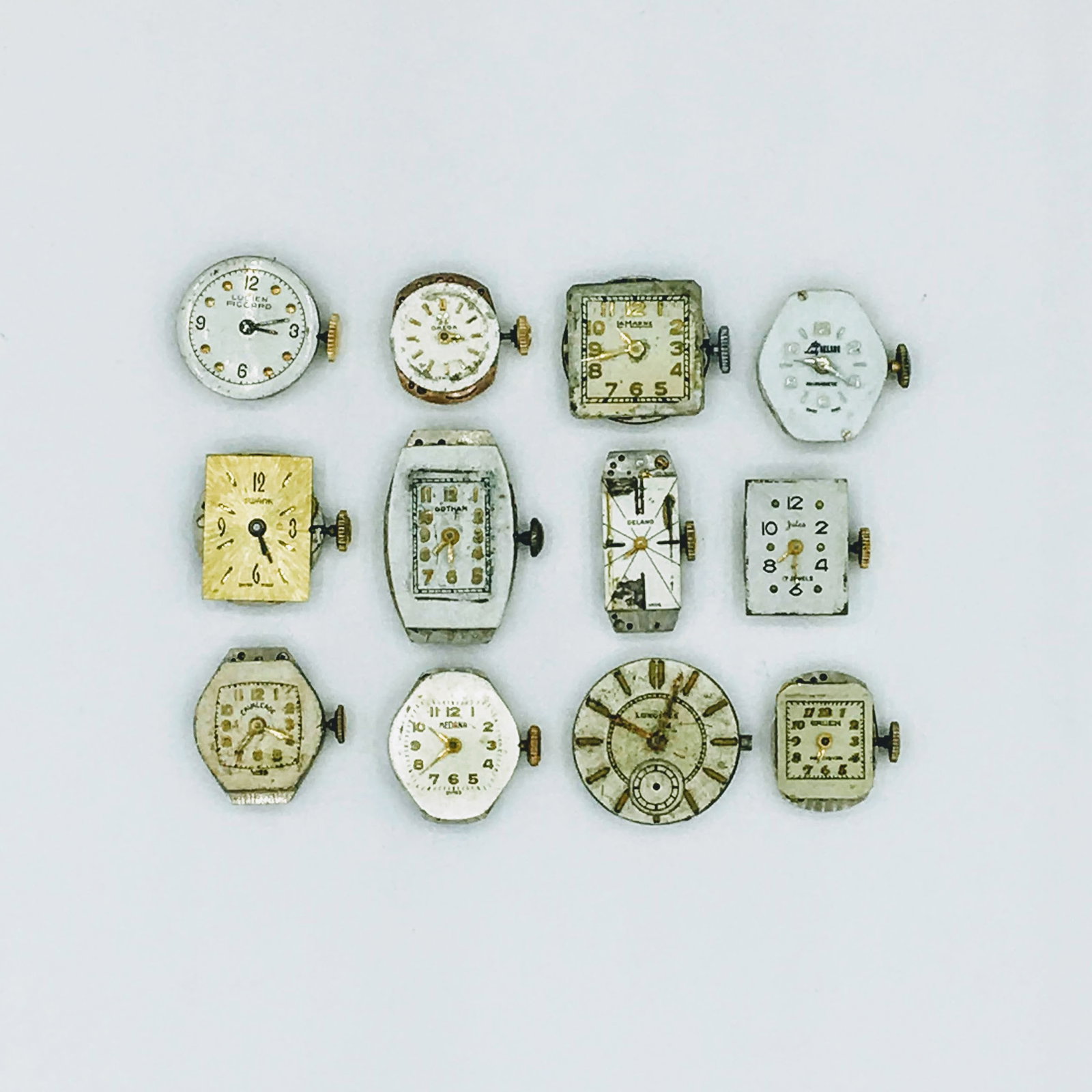 Lot 12 Vintage Swiss Ladies Wrist Watch Movements Gruen Gotham Lucien Piccard: Lot 12 Vintage Swiss Ladies Wrist Watch Movements Gruen Gotham Lucien Piccard. Longines, Cavalcade, Jules, La Marne, Delano, Omega, Medana, Lady Nelson, and Swank. Condition Appropriate with Age and a