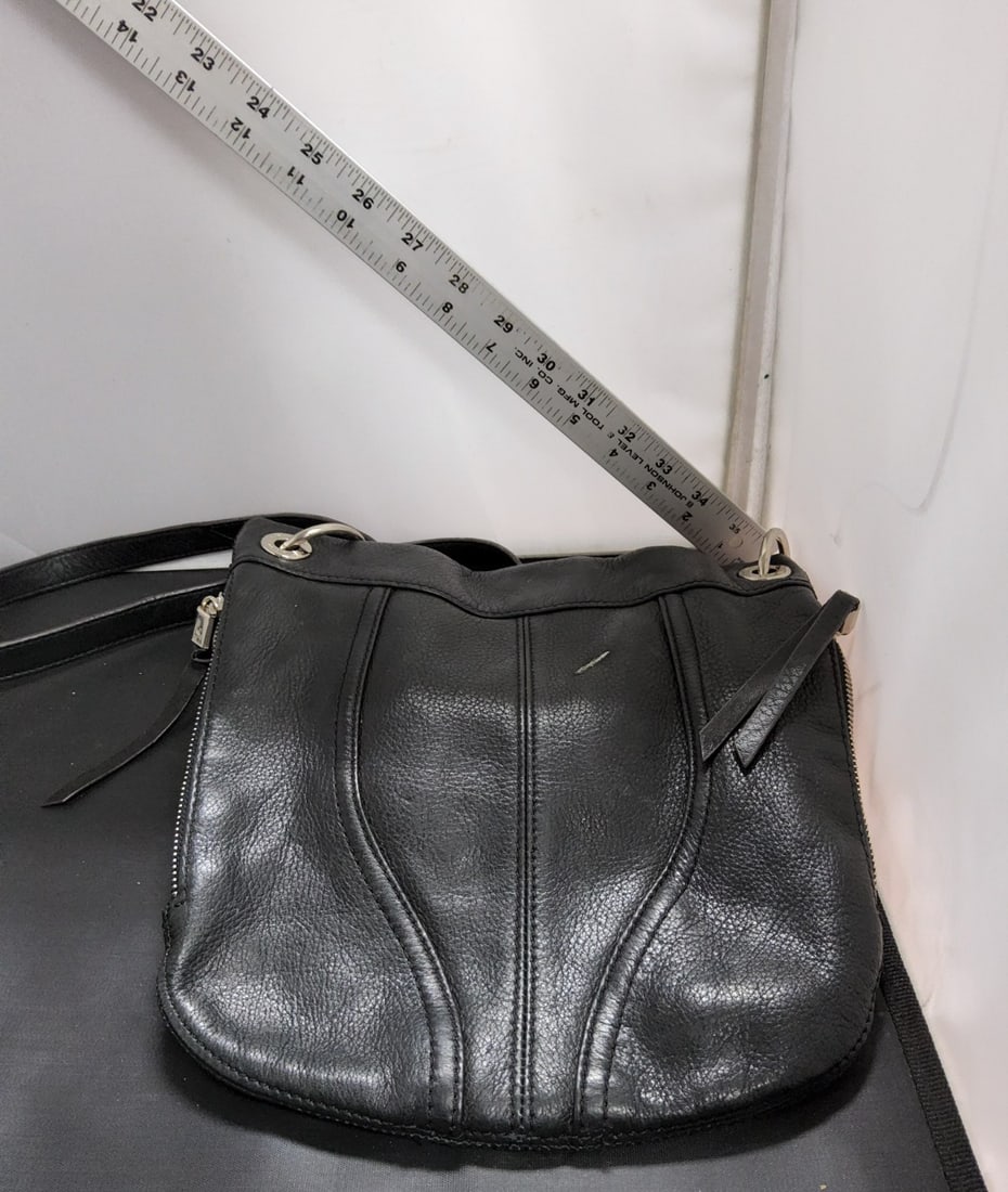 B. Makowsky Black Leather Handbag: The B. Makowsky Black Leather Handbag is a stylish and practical accessory for women. Made from high-quality leather with a pebbled finish, this medium-sized shoulder bag features a classic rectangle