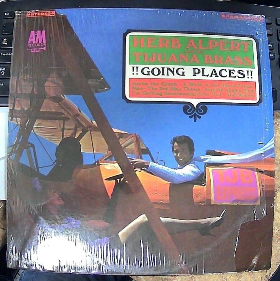 Herb Alpert & The Tijuana Brass - !!Going Places!! - A&M Records - SP-4112 - LP,: Get ready to travel back in time with this LP from Herb Alpert & The Tijuana Brass. The record features 33 RPM speed and a 12" record size, and is housed in a cardboard sleeve. The record label is