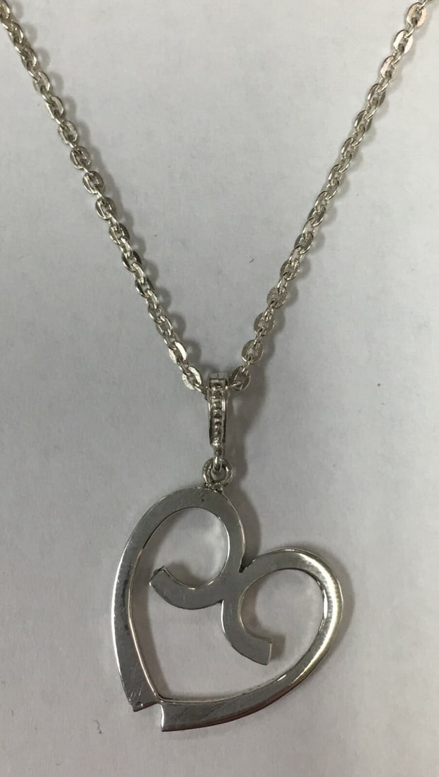 Beautiful Silver Plated Heart Pendant Necklace 20".: This necklace is in excellent condition with a little signs of wear seen. It measures about 20 inches long with a heart size 6/8" by 6/8". Please, review pictures for additional details. This pretty n