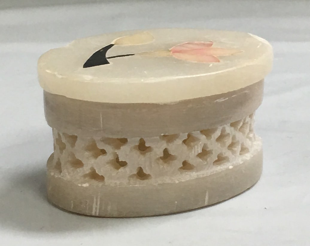 Vintage Hand Made in India Fetco Oval Soapstone Trinket Box with Flower Inlay: This box is in good condition with signs of wear like two chips on the top as shown in the photos. It measures about 1 1/8" by 2 1/8" by 1 1/2". Please, review pictures for condition and details.