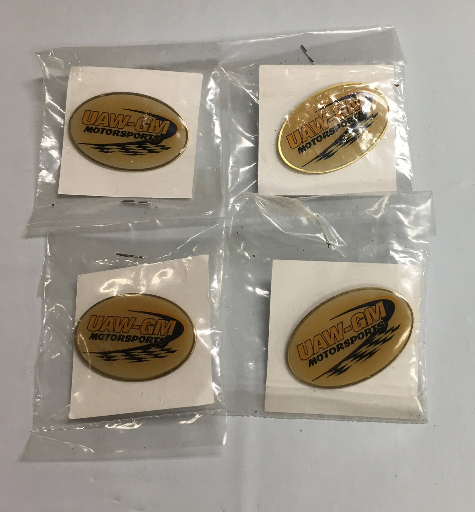 Set of 4 UAW-GM Motorsports Racing Logo NASCAR Oval Hat Pin: These pins are brand new in original packaging. Please, review pictures for additional details.