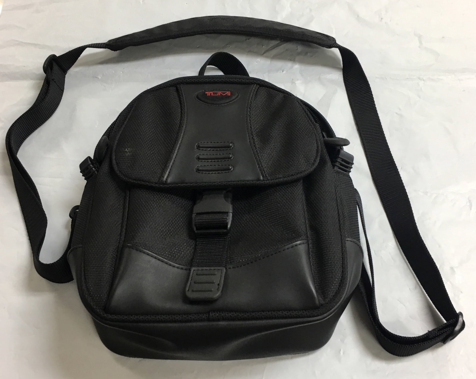 Tumi Men's Sling (10x11x2.5) Removable Tote Small Shoulder Bag in Black: This bag is overall in excellent condition with one light spot in the front as shown in the photos 1, 2 & 3. It measures about 10" by 11" by 2. 1/2". There is one zipped pocket inside the bag, one zip