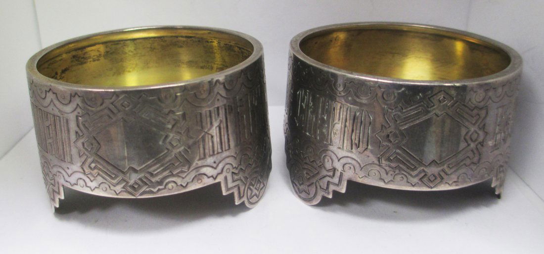 PR RUSSIAN ANTIQUE VODKA CUP HOLDERS: Each Antique Vodka Cup Holder is Stamped and Marked. Dated 1881, and 1883. 84 Silver Purity Mark, with Maker's Mark. Each Cup has engraved Cyrillic Writing on Front. Three Footed Base. Measures 2" Dia