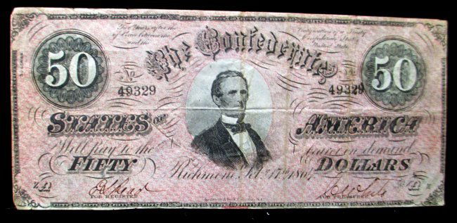 U.S. CONFEDERATE STATES OF AMERICA $50 DOLLAR BILL: The $50 Confederate note has a picture of Jefferson Davis in the center. This note was printed with black ink and a pink overprint on the front and with blue ink on the back. The condition is over all