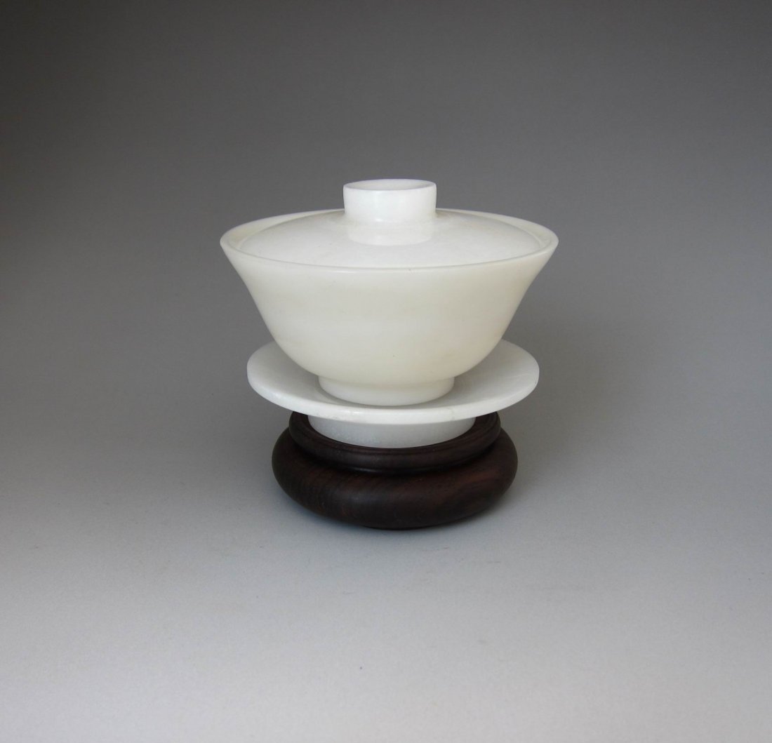 Chinese Natural Jade Cap: Chinese NaturalJade Cap , resting on carved hardwood stand. Cap Size: 7.5cmHx10cm W Hardwood stand 7.2cm W . total height 9.6cm