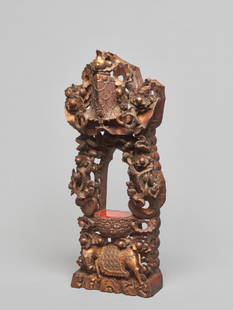 A CARVED WOODEN ZEN BUDDHISM SHRINE, QING DYNASTY: Carved wood with original lacquer gilding, the base for the center piece with original cinnabar red lacquer coating, overall reticulated sculptural carving. China, late Qing dynasty One of the Ten Bul