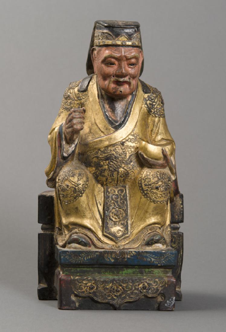 IMPERIAL DIGNITARY ON A THRONE: Wood with gilding. China, Qing-dynasty (1644-1911) Tiered throne with floral decoration,; golden robe with fine plaster decoration, in which multiple fenghuan (phoenixes) are depicted, even inside the
