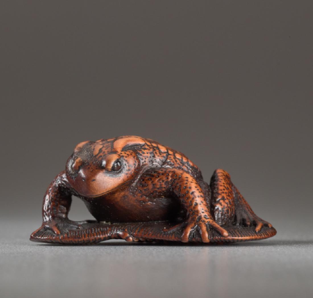 A WOOD NETSUKE BY TANRI OF A TOAD ON A SANDAL (1 of 5)