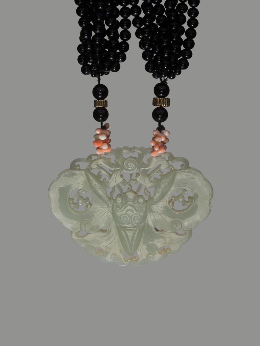 A PIERCED CELADON JADE 'BUTTERFLY'PLAQUE, QING (1 of 3)