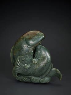 A LARGE SPINACH-GREEN JADE 'DOUBLE CARP' GROUP, QING: A LARGE SPINACH-GREEN JADE 'DOUBLE CARP' GROUP, QING DYNASTY Nephrite of a pure and deep spinach-green tone accentuated with intense russet inclusions on the head of the upper carp, and some white and