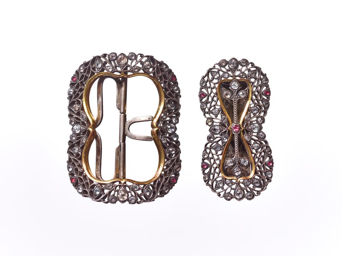 A MASSIVE SILVER TWO-PART BELT BUCKLE: A MASSIVE SILVER TWO-PART BELT BUCKLE WITH OPEN WORK AND INSET STONES Burma, dated 1920, inscription on backside of bridge This large and highly decorative Burmese two-part belt buckle is made of silv
