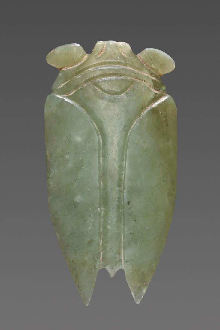 A SUPERB HAN CICADA IN LIGHT GREEN JADE: A SUPERB HAN CICADA IN LIGHT GREEN JADE Jade China, Han dynasty (206 BC-220 AD), 2nd to 1st century BC This beautiful Han cicada in light green jade is masterfully carved as seen from above. It is bas