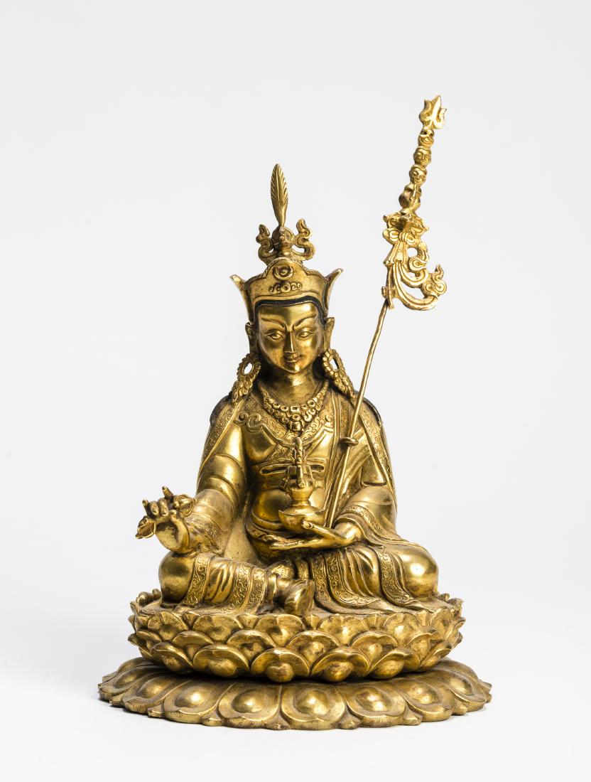 A SINO-TIBETAN BRONZE STATUE OF PADMASAMBHAVA, 20TH C.: A SINO-TIBETAN BRONZE STATUE OF PADMASAMBHAVA, 20TH CENTURY Bronze Tibet/China, 20th century Padmasambhava, also known as Guru Rinpoche, is seated on a lotus throne, holding a vajra in one hand and th