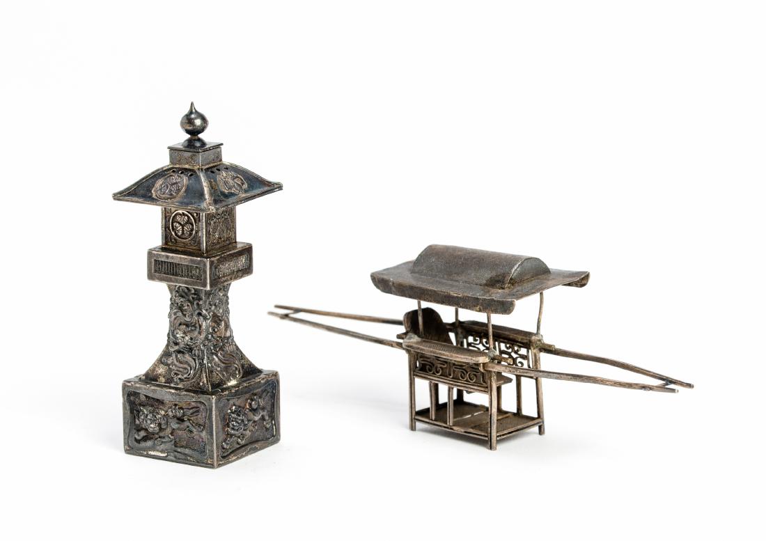 TWO SILVER OBJECTS: TWO SILVER OBJECTS Silver China, around 1900 One shaped as a salt shaker in the form of a pagoda with Buddhist lions in and dragons. The other in the form of rikshaw. Both with hallmarks. Dimensions: 