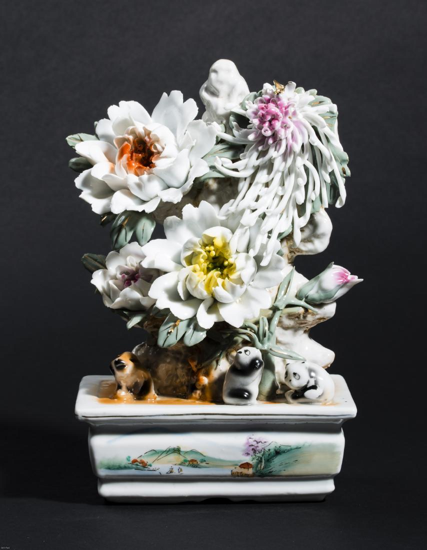 A PORCELAIN SCULPTURE WITH BLOSSOMS: A PORCELAIN SCULPTURE WITH BLOSSOMS Porcelain China, Mao Zhedong period, 20th cent. A very fine example of elaborate craftsmanship, offering a composition of various blossoms, a hound and two pandas, 