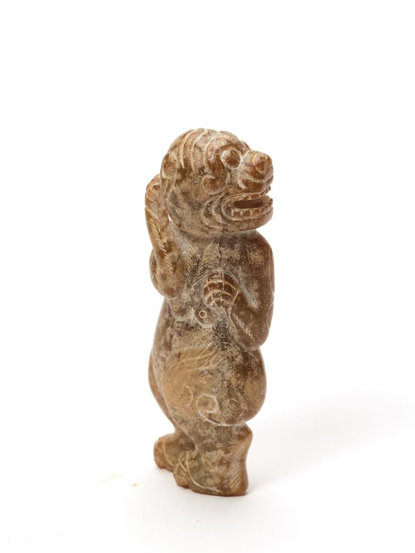 A HAN DYNASTY STYLE JADE FIGURE OF A STANDING TIGER: A HAN DYNASTY STYLE JADE FIGURE OF A STANDING TIGER Brown jade, opaque, hand carved China This brown jade figure shows a tiger standing upright and scratching its head. Its pose and breasts give it an