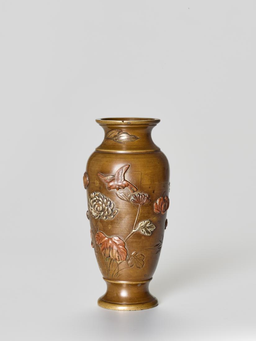 A SMALL MIXED METAL VASE WITH BIRDS AND FLOWERS: A SMALL MIXED METAL VASE WITH BIRDS AND FLOWERS Sentoku with shibuichi and silver inlay Japan, Meiji period (1868-1912), late 19th century A small baluster-shaped vase with a wide base and neck. The v
