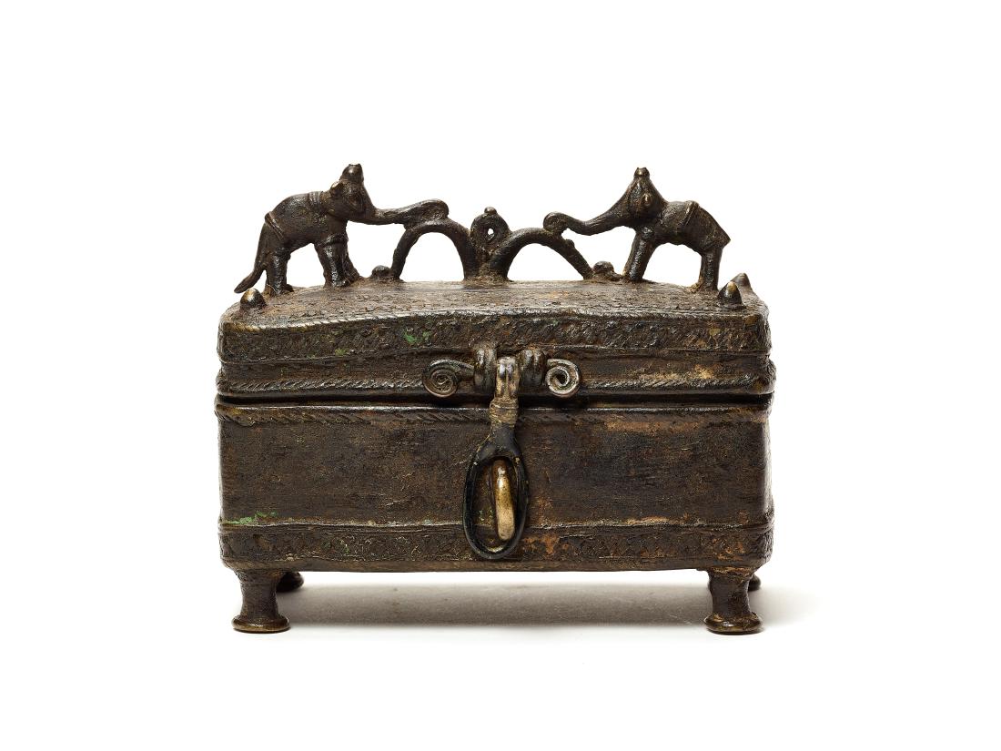 AN INDIAN TRIBAL BRONZE CASKET WITH ELEPHANTS, 19TH C.: AN INDIAN TRIBAL BRONZE CASKET WITH ELEPHANTS, 19TH CENTURY Bronze India, 19th century The tribal bronze casket is decorated with geometric lines around the lower area as well as the hinged lid, which