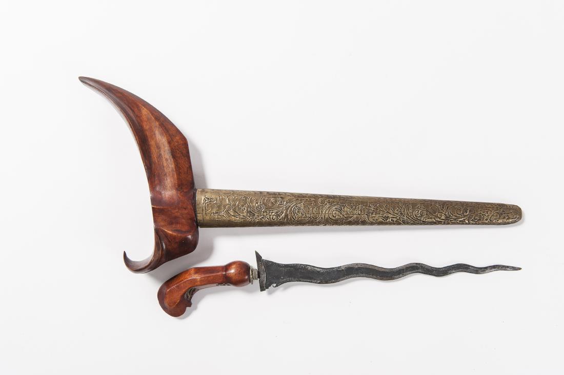 AN INDONESIAN KRIS, 19TH TO FIRST HALF OF THE 20TH C.: AN INDONESIAN KRIS, 19TH TO FIRST HALF OF THE 20TH CENTURY Metals, wood Indonesia, 19th to first half of the 20th century A narrow, wavy blade with ten Luk, an elephant trunk and a protruding thorn-sh