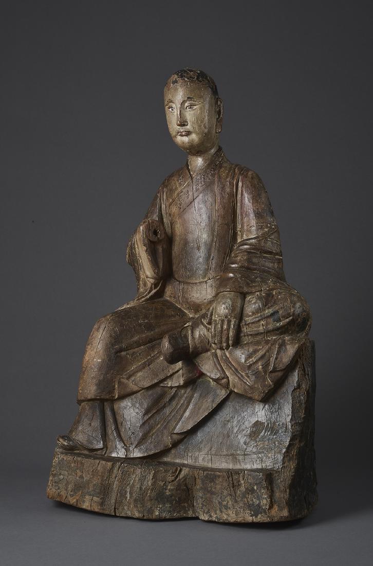 A MING WOOD AND GESSO MAUDGALYAYANA: A MING WOOD AND GESSO MAUDGALYAYANA China, Ming Dynasty (1368-1644). Masterly carved, highlighted with gesso and lacquer, this prominent wood statue depicts Maudgalyayana (Mulian in Chinese), one of B