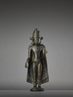 A KURKIHAR CROWNED BUDDHA BRONZE: A KURKIHAR CROWNED BUDDHA BRONZE India, Bihar, Pala Period, 11th - 12th century. Heavily cast and displaying a warm authentic patina, this bronze depicts Buddha in a standing pose atop a small plinth.