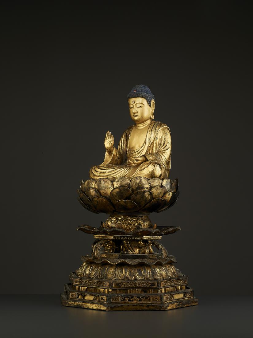 A LARGE AMIDA BUDDHA EDO PERIOD: A LARGE AMIDA BUDDHA EDO PERIOD Japan, 18th - earlier 19th century. Carved, lacquered and gilt wood figure of Amida Buddha on a large and matching openwork base. HEIGHT 52 cm WEIGHT 2.7 kilograms Pro