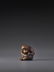 A WOOD NETSUKE OF A GROOMING MONKEY SIGNED OKATOMO