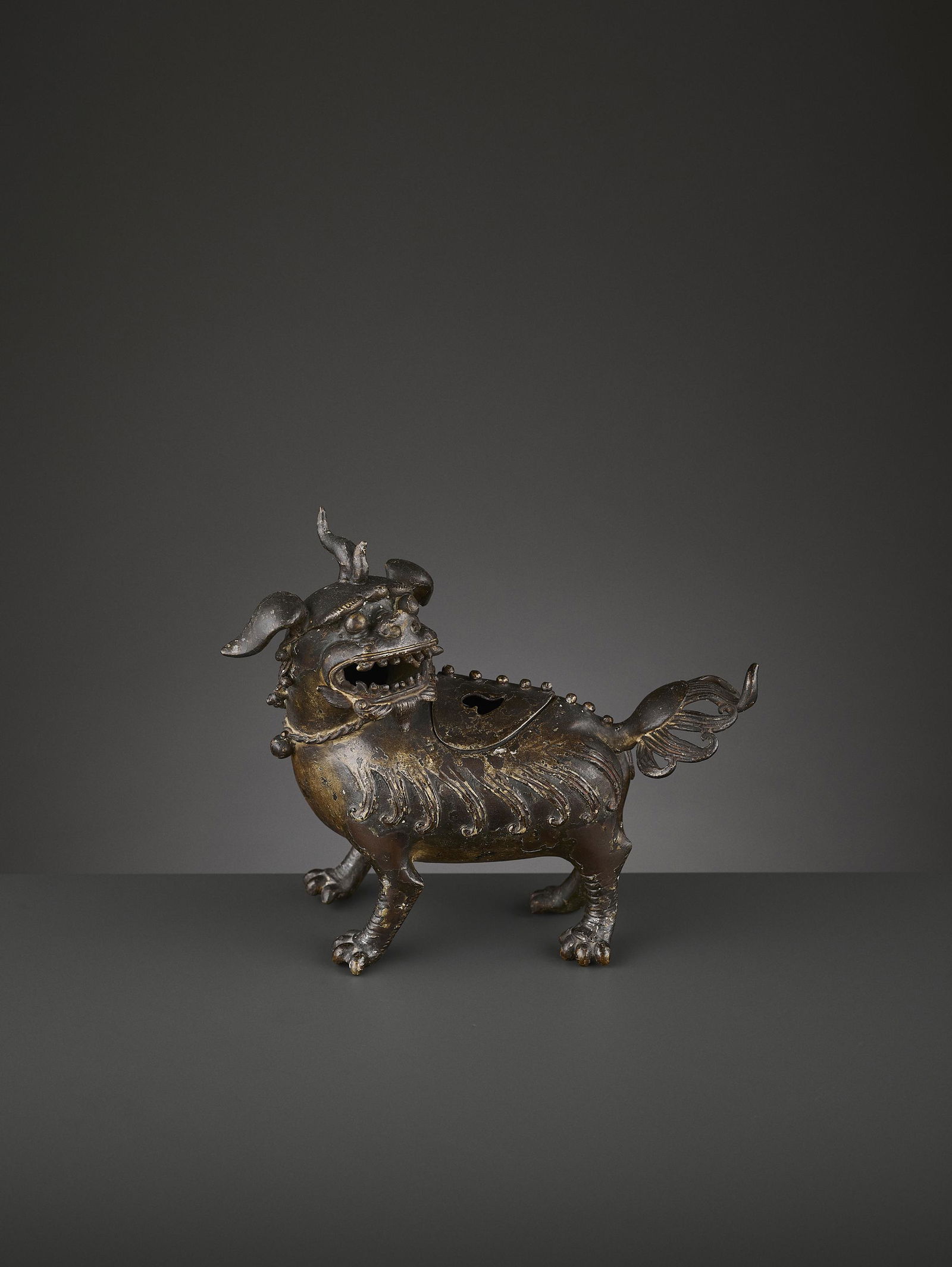 A LUDUAN BRONZE CENSER, MING: A LUDUAN BRONZE CENSER, MING China, 1368-1644. The bronze vessel with a pierced and removable lid, where the incense is inserted, the smoke then dramatically escaping through the luduan's mouth. The b