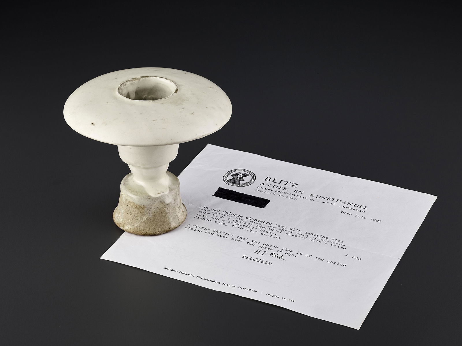 A CIZHOU OIL LAMP STAND XING LU, SONG: A CIZHOU OIL LAMP STAND XING LU, SONG China, Northern Song - Jin Dynasty (960-1234). The lamp with a tapering stem and a splayed high foot, the upper part of mushroom form with a central aperture. Cov