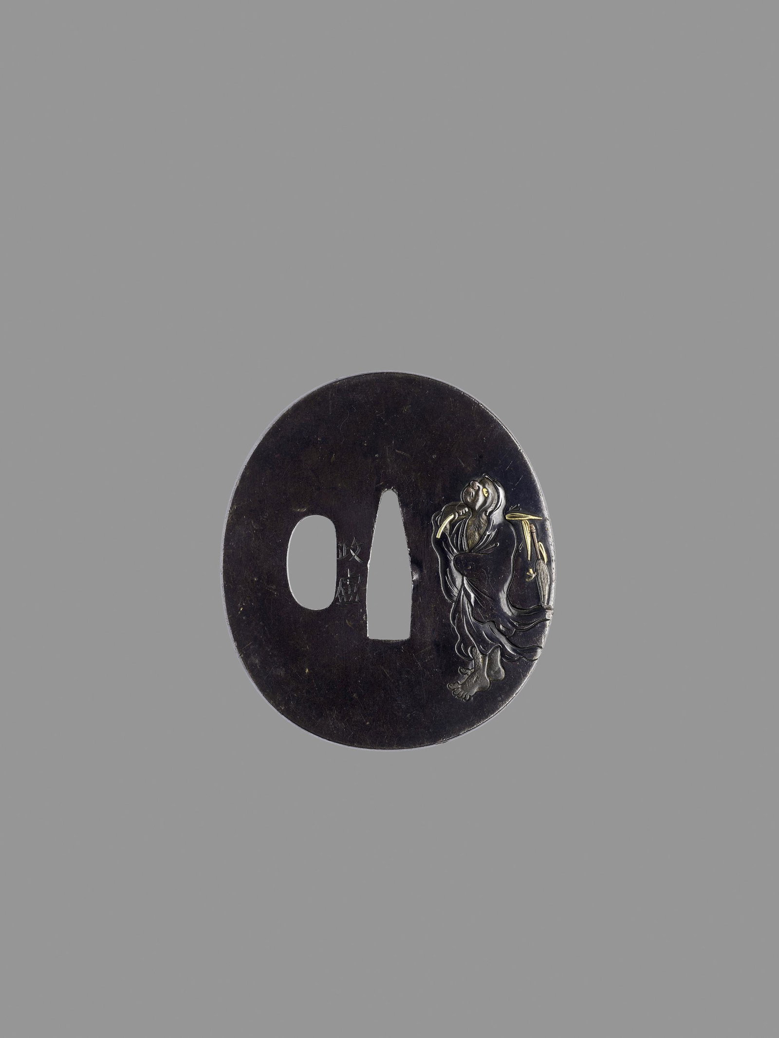 MASAYOSHI: A SHIBUICHI TSUBA WITH DARUMA: MASAYOSHI: A SHIBUICHI TSUBA WITH DARUMA Signed Masayoshi Japan, 19th century, Edo period (1615-1868) A shibuichi tsuba of marugata type, carved on one side in sunken relief with an image of the Zen-p