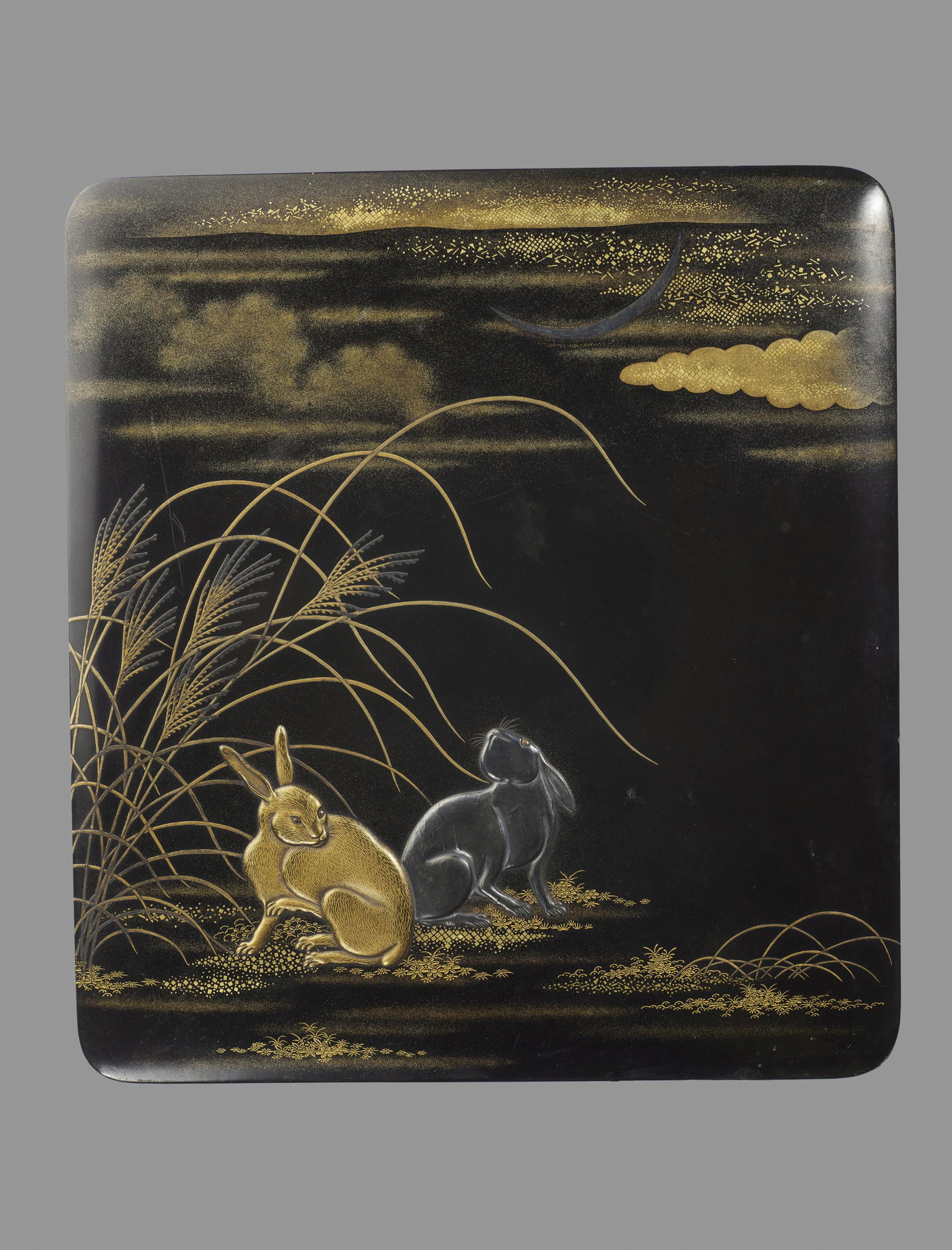 A FINE LACQUERED SUZURIBAKO WITH LUNAR HARES: A FINE LACQUERED SUZURIBAKO WITH LUNAR HARES Japan, late 18th - earlier 19th century, Edo period (1615-1868) Finely decorated in takamaki-e and hiramaki-e gold, silver and dark-brown lacquer with two 