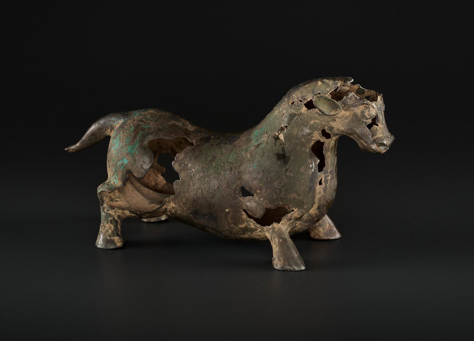 A BRONZE BULL, LATE WARRING STATES TO EARLY HAN: A SUPERB BRONZE FIGURE OF A BULL, LATE WARRING STATES TO EARLY HAN DYNASTY China, probably Kingdom of Dian, 3rd-2nd century BC. Hollow cast, the stocky, muscular bull standing four square on distinct 