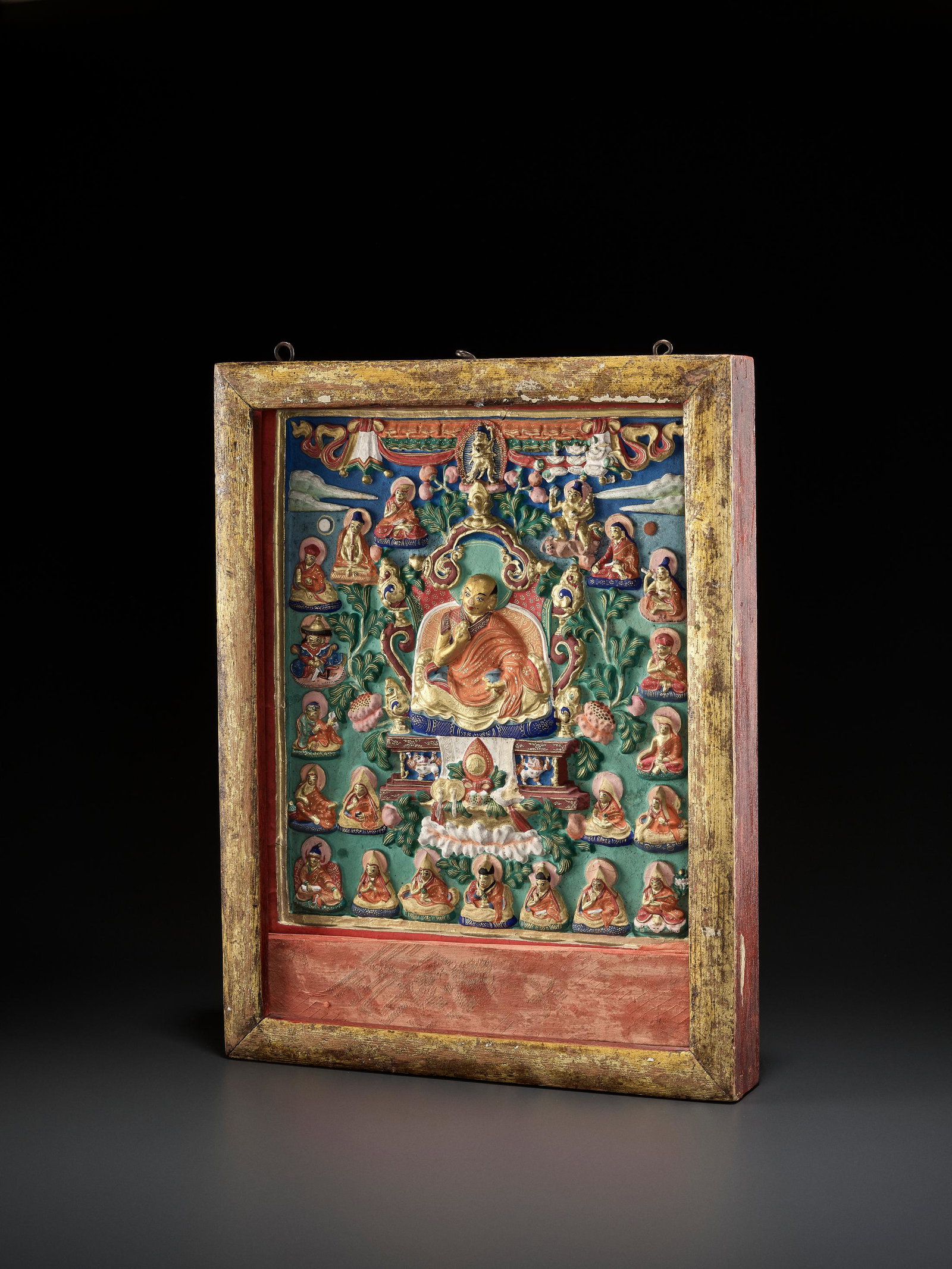 A LARGE POLYCHROME TSA-TSA OF ZANABAZAR, 19TH CT: A LARGE POLYCHROME TSA-TSA OF ZANABAZAR, 19TH CENTURY Mongolia. The terracotta finely modeled, painted and gilt with a portrait of OEndoer Gegeen Zanabazar seated on an elaborate throne with Buddhist 