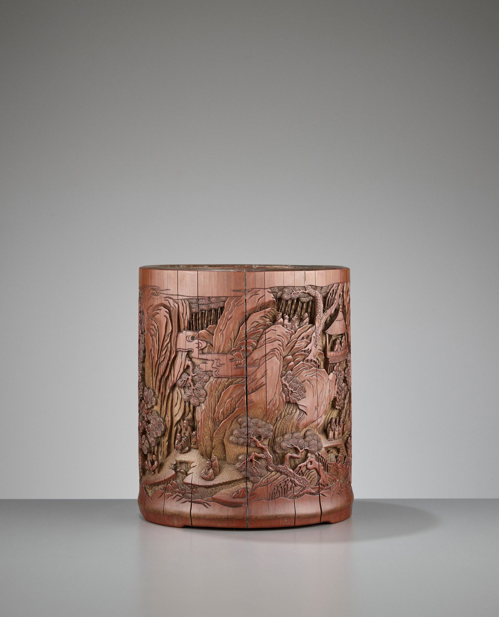A 'SEVEN SAGES' BAMBOO BRUSHPOT, QING: A 'SEVEN SAGES OF THE BAMBOO GROVE' CARVED BAMBOO BRUSHPOT, QING China, dated Jiachen year (most likely 1784), signed Jingfeng Shanren. Elliptic form, carved with two scenes, each depicting the Seven 
