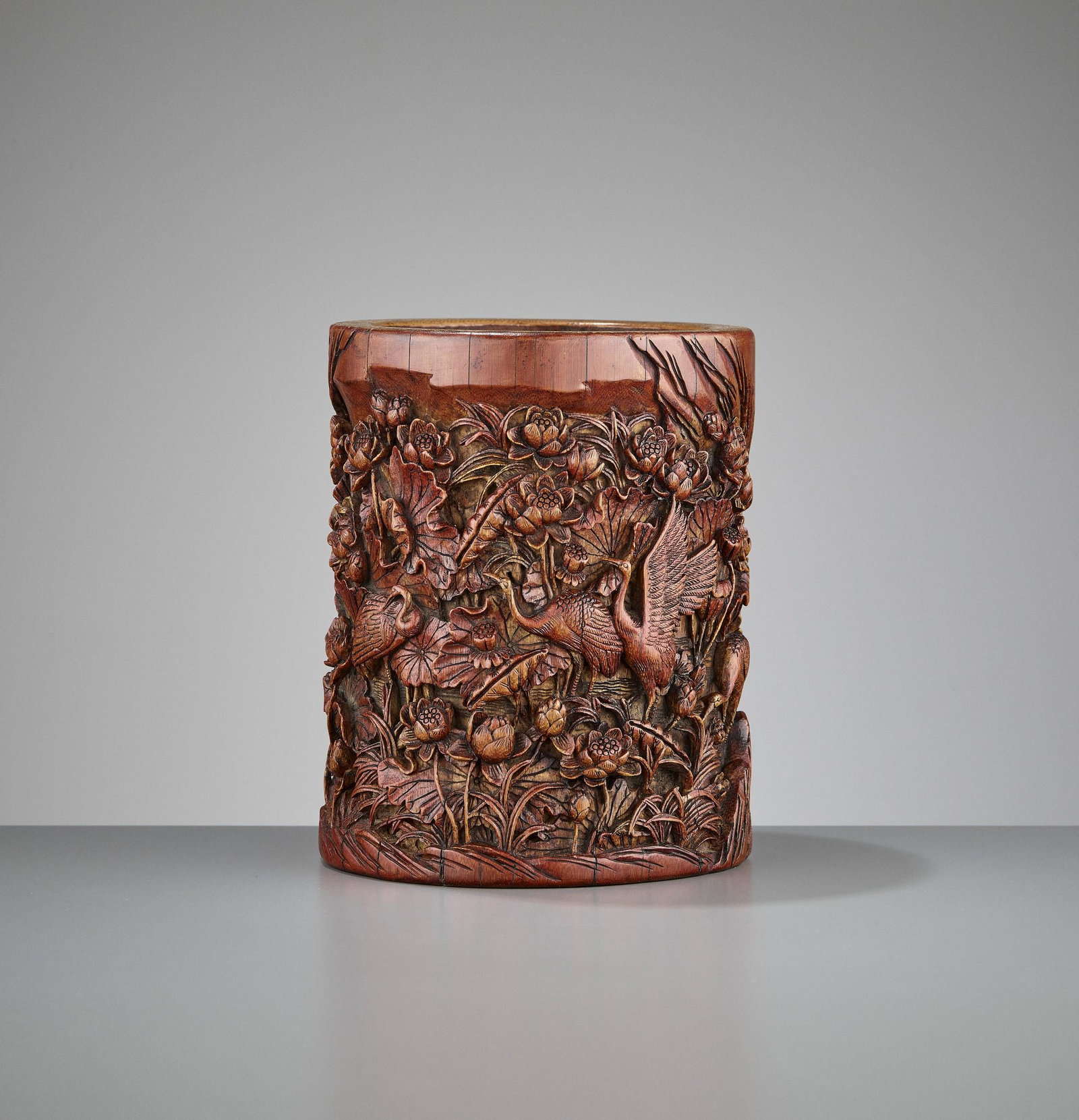 A RETICULATED BAMBOO BRUSHPOT, WANG PI, QIANLONG: A RETICULATED BAMBOO ' CRANES IN LOTUS POND' BRUSHPOT, BY WANG PI, QIANLONG China, 1735-1796. The carving shows a sheer incredible density combined with an extremely high relief, showing reticulation 