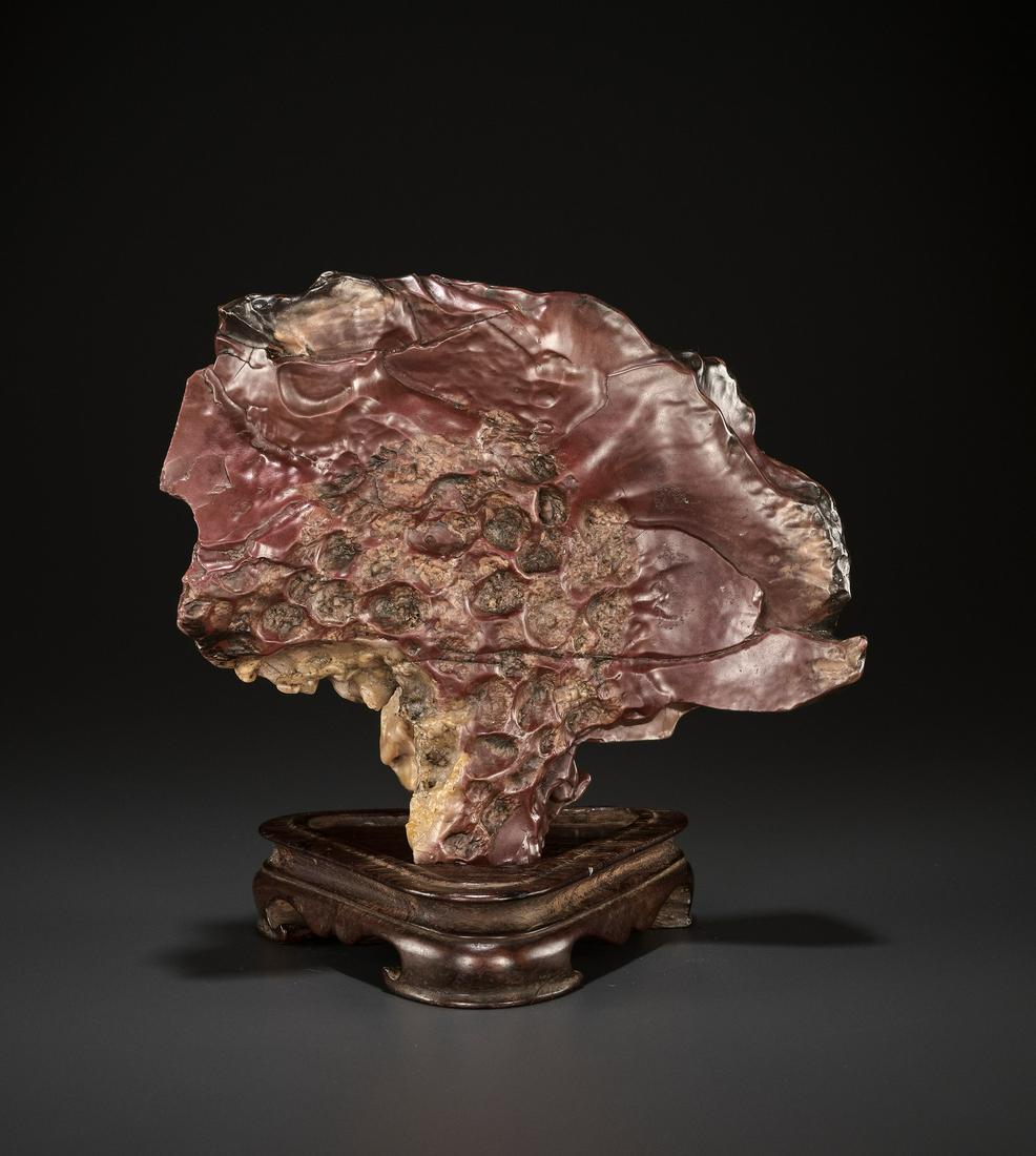 A MINIATURE SCHOLAR'S ROCK, LATE MING DYNASTY: A RARE MINIATURE SCHOLAR'S ROCK, LATE MING TO EARLY QING DYNASTY China, 17th - 18th century. The fungus-shaped conglomerate rock is resting on its narrowest point and expands through a series of drama