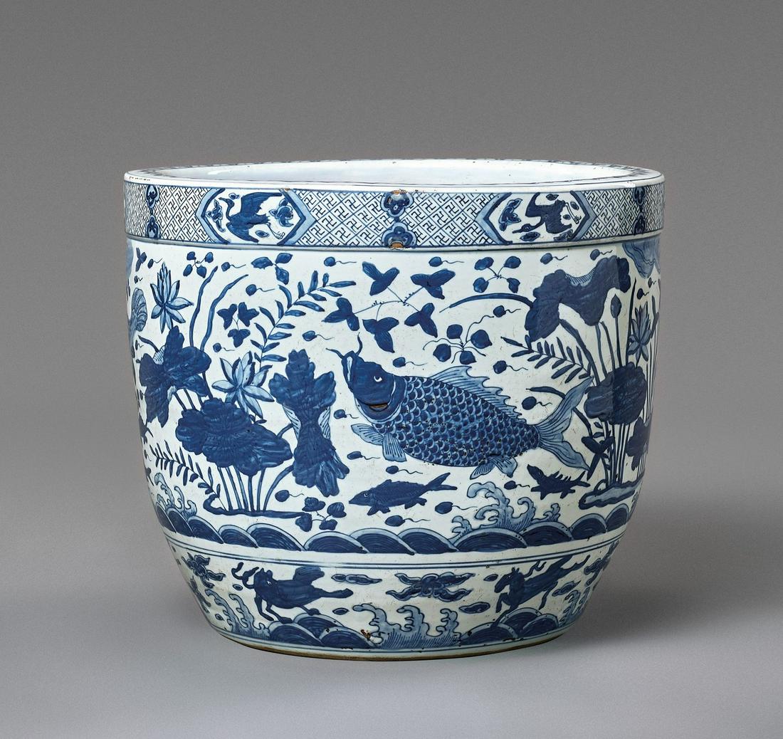 A MASSIVE BLUE AND WHITE FISHBOWL, MING DYNASTY: A MASSIVE BLUE AND WHITE FISHBOWL, MING DYNASTY China, 16th to early 17th century. The large and very heavy vessel with gently flaring sides, skillfully painted around the exterior in a vibrant and in
