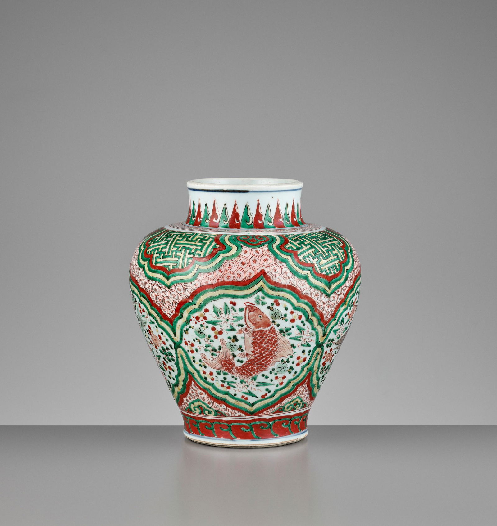 A WUCAI BALUSTER 'FISH' JAR, TRANSITIONAL PERIOD: A WUCAI BALUSTER 'FISH' JAR, TRANSITIONAL PERIOD China, 17th century. Finely decorated in emerald-green and limeyellow enamels as well as iron-red above the glaze to depict mullet, sole, bream and per