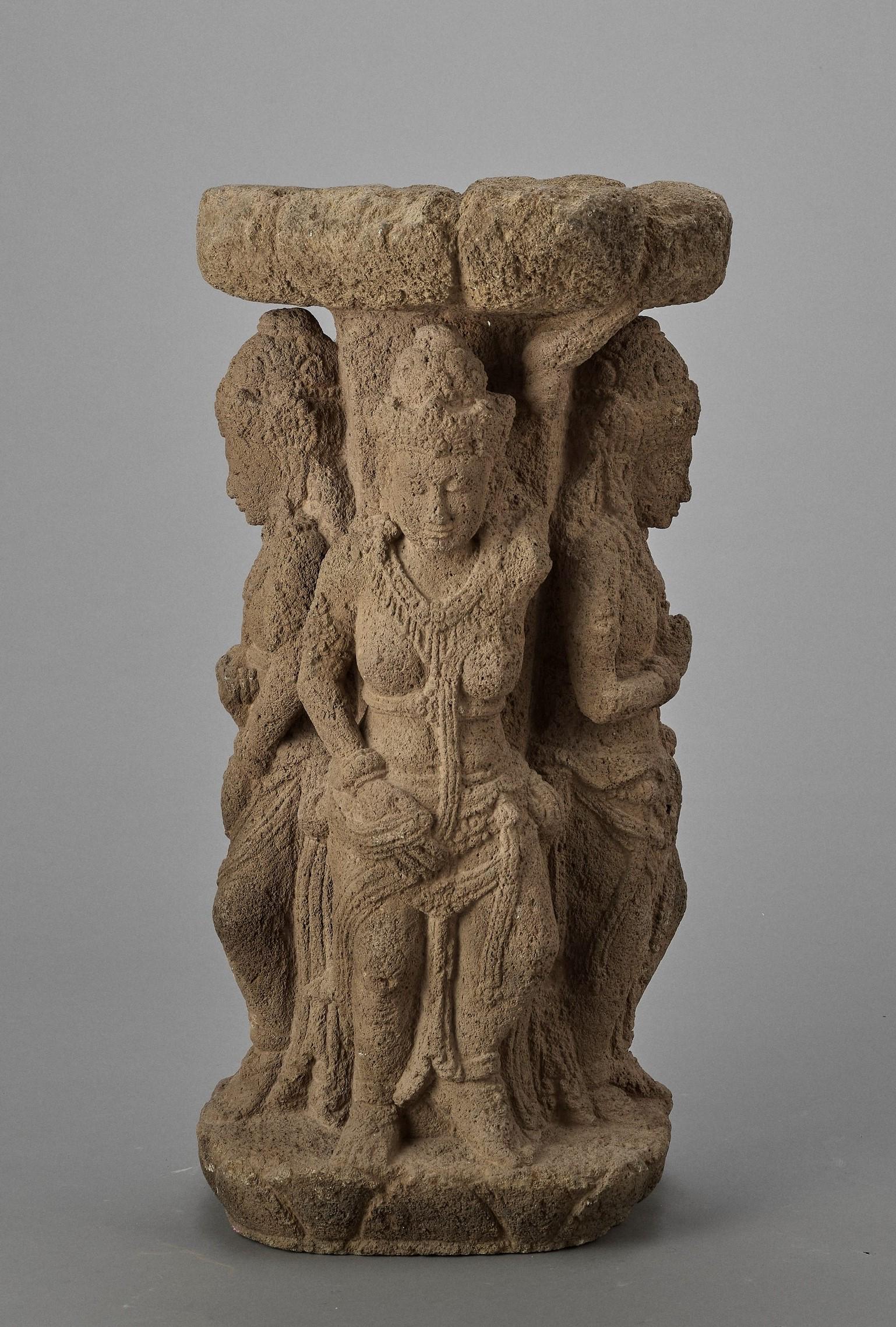 A LARGE ANDESITE BASIN, CENTRAL JAVA, 9TH CENTURY: A LARGE ANDESITE BASIN WITH FOUR DEITIES, INDONESIA, CENTRAL JAVA, 9TH CENTURY Two male and two female standing deities support a lotus-shaped water basin. The figures wear elaborate crowns and jewelr