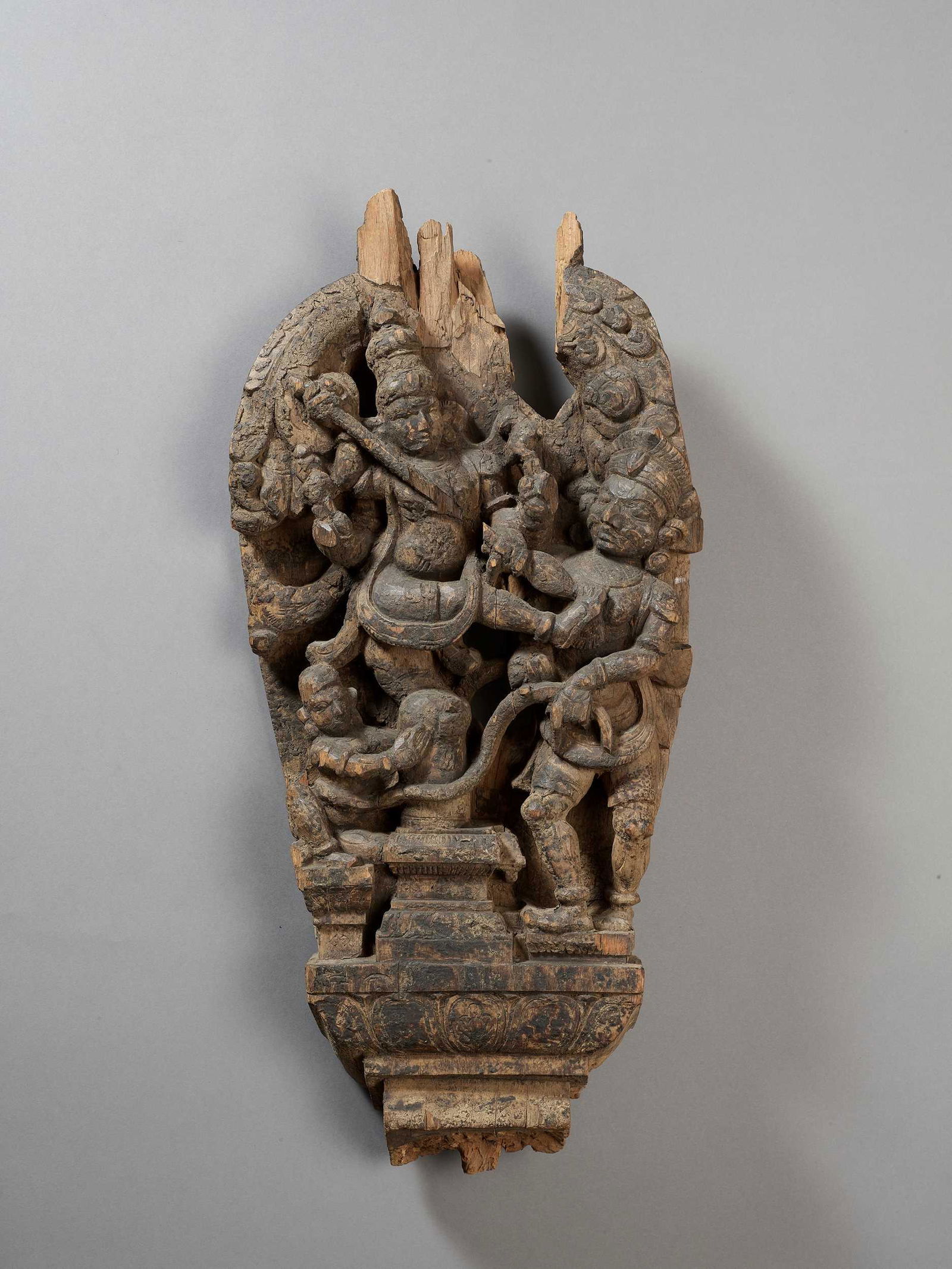 A LARGE WOOD STELE OF DURGA VANQUISHING A DEMON (1 of 4)
