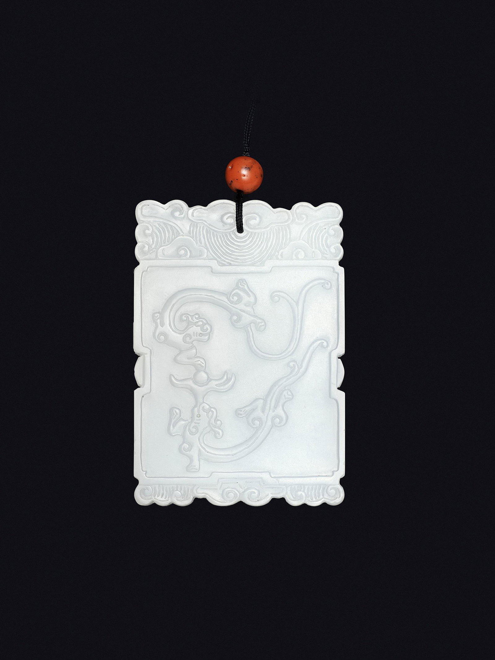 A WHITE JADE 'FUGUI' PLAQUE, MID-QING TO REPUBLIC: A WHITE JADE 'FUGUI' PLAQUE, MID-QING TO REPUBLIC China, 1750-1949. Of rectangular form, finely carved to one side in relief with two sinuously coiled chilong with bifurcated tails chasing a flaming p