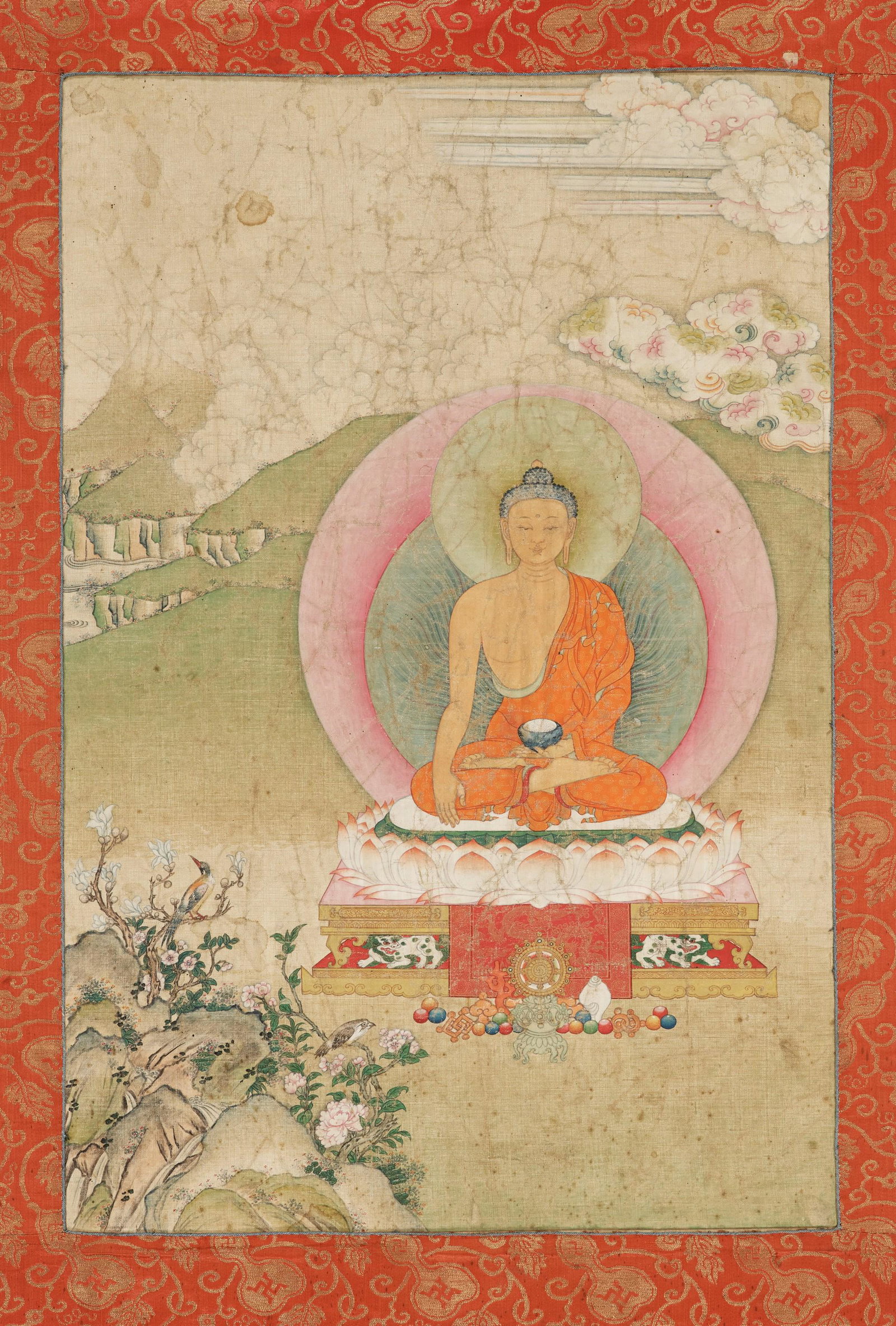 A THANGKA OF BUDDHA SHAKYAMUNI, 18TH-19TH CENTURY: A THANGKA OF BUDDHA SHAKYAMUNI, 18TH-19TH CENTURY Tibet. Distemper on cloth. Seated in dhyanasana on a lotus throne supported by snow lions with offerings and Buddhist emblems placed before him, his r
