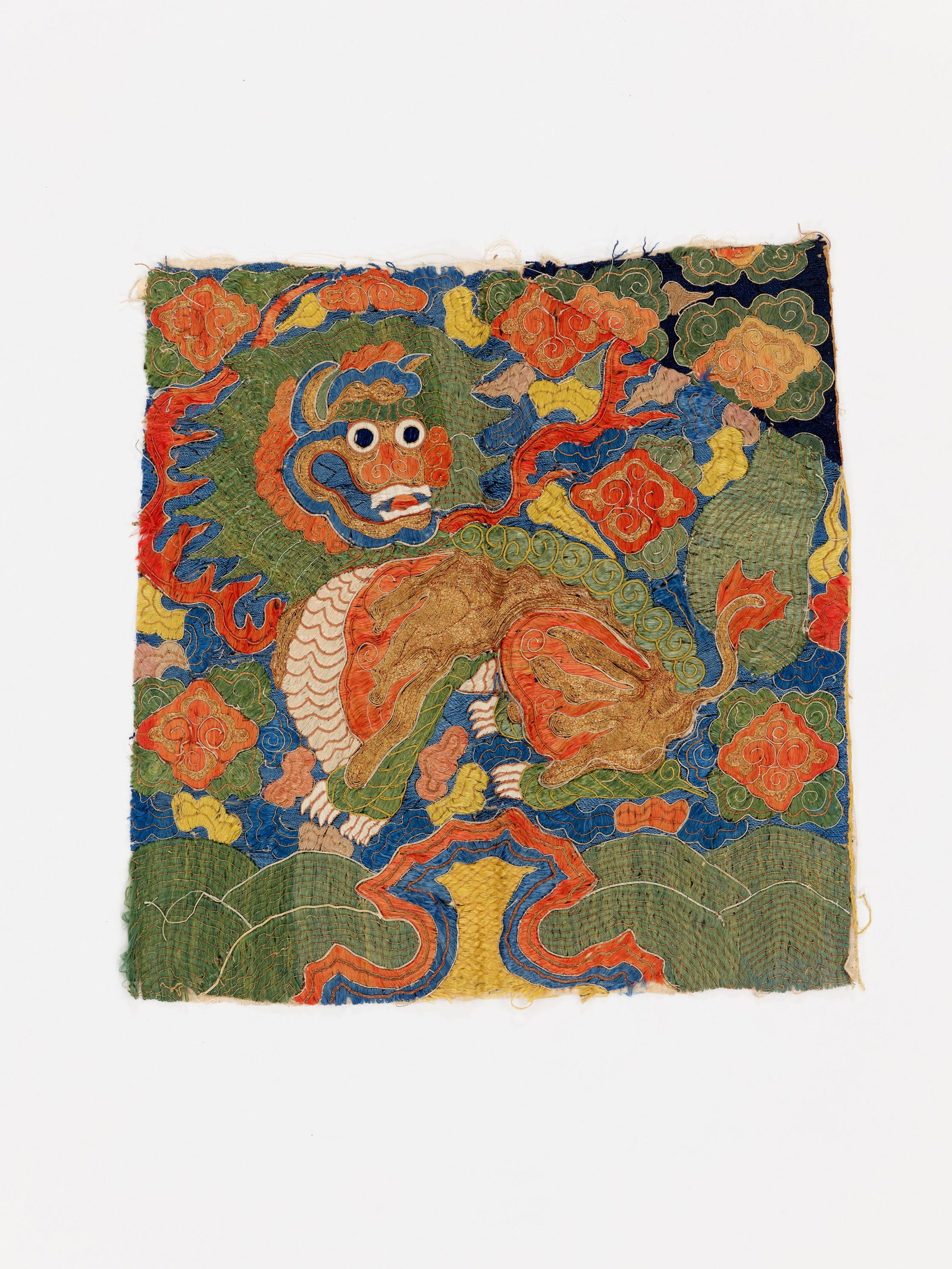 A RARE MILITARY OFFICIAL'S BUZI, LATE MING: A RARE MILITARY OFFICIAL'S RANK BADGE OF A LION, BUZI, LATE MING DYNASTY China, 17th century. Made for a second rank military official. Embroidered with a Buddhist lion seated atop a rocky outcrop ove