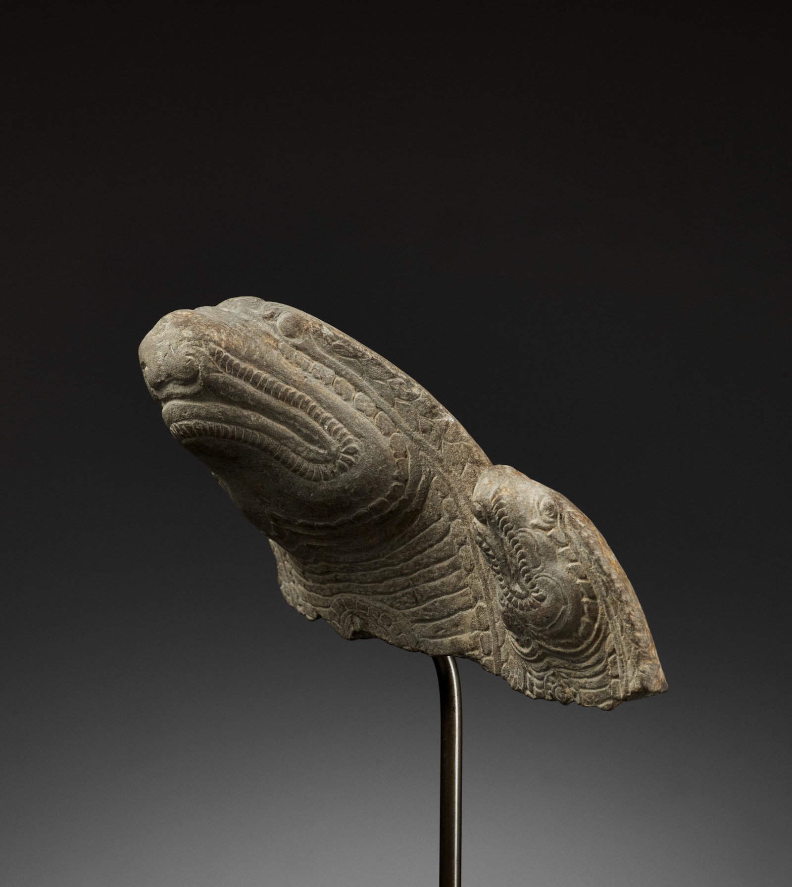 A KHMER SANDSTONE FRAGMENT OF TWO NAGAS, BAYON: A KHMER SANDSTONE FRAGMENT OF TWO NAGAS, BAYON STYLE Khmer Empire, 12th-13th century. This expressively carved and incised fragment was once part of a very large Buddha Muchalinda statue, depicting a 
